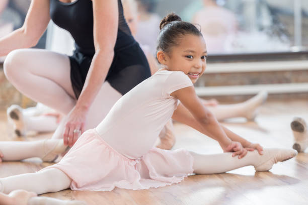istock Young ballerina does the splits during practice 813537842