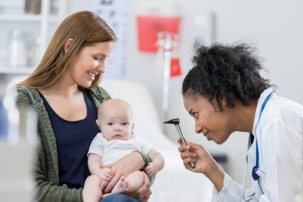 istock Caring pediatrician examines baby girl 813537976