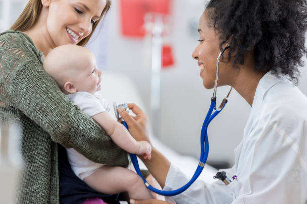 istock Caring pediatrician listens to baby's heart 813537980