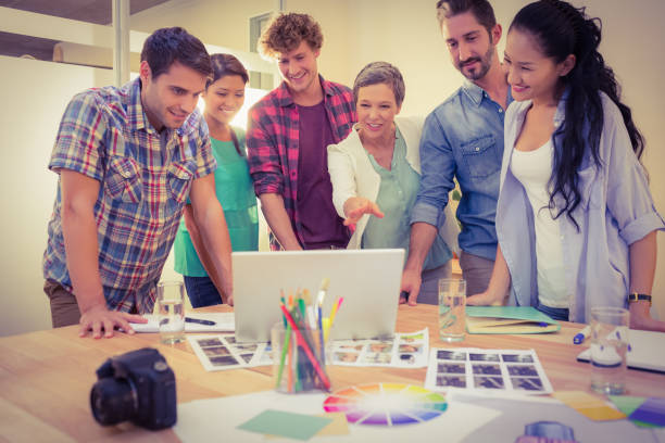 istock Happy creative business team using laptop in meeting 813538064