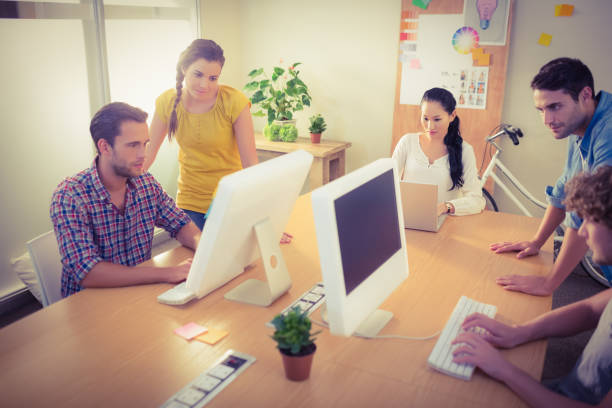 istock Attentive business team working on laptops 813540492