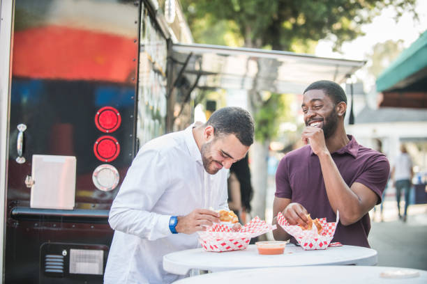 Multi Ethnic Friends Eating from the Food Trucks