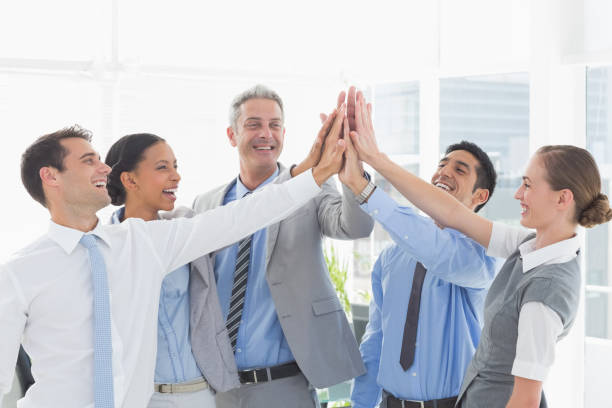 istock Business people cheering in office 813556700