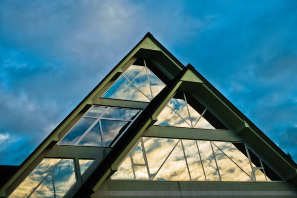 istock Reflection of a sky in a triangle glass shape on a building at Bled 813556878