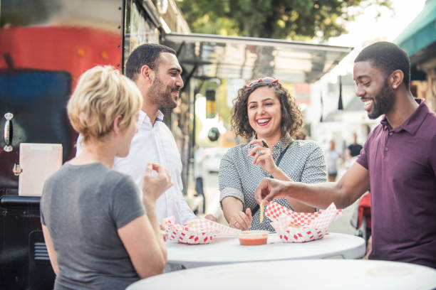 istock Multi Ethnic Friends Eating from the Food Trucks 813562284