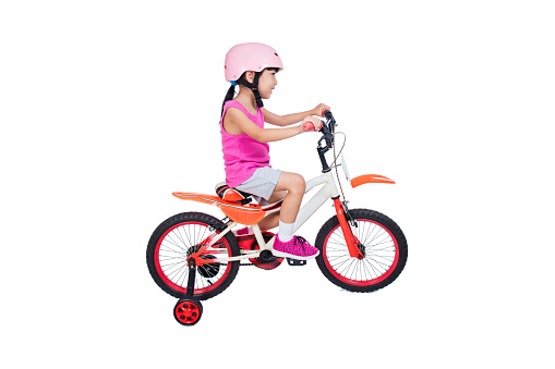Asian Chinese little girl riding bicycle in isolated white background