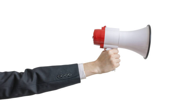 istock Hand is holding megaphone. Isolated on white background. 813565488