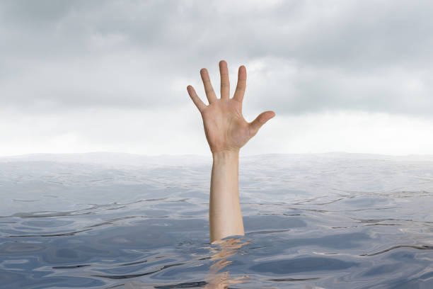 istock Man is drowning in ocean. Only hand is visible. 813565554