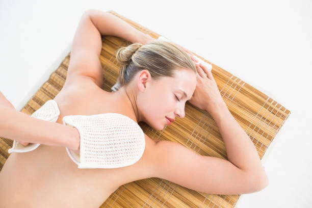 Cute young woman enjoying during a skin care treatment at a spa.