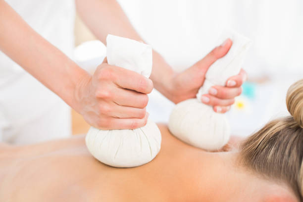 istock Beautiful blonde enjoying a herbal compress massage 813570418