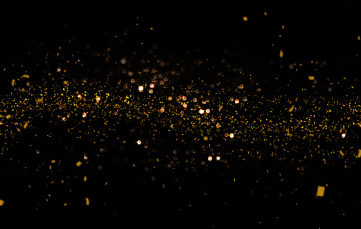 Waving golden glitter and confetti