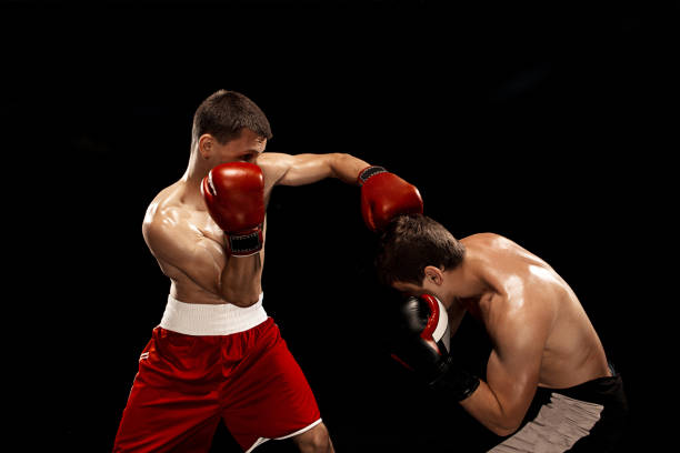 istock Two professional boxer boxing on black smoky background 813575494