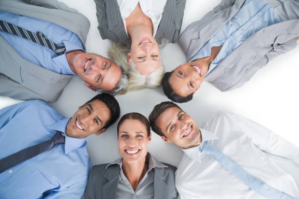 istock Young business people lying in circle 813581520
