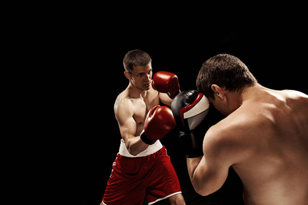 istock Two professional boxer boxing on black background 813585692