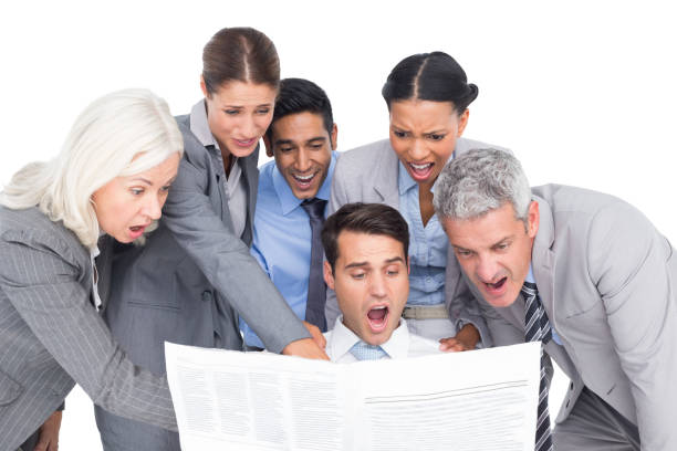 istock Surprising business people looking at newspaper 813585722