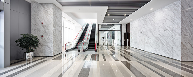 interior of center with escalator in modern office building