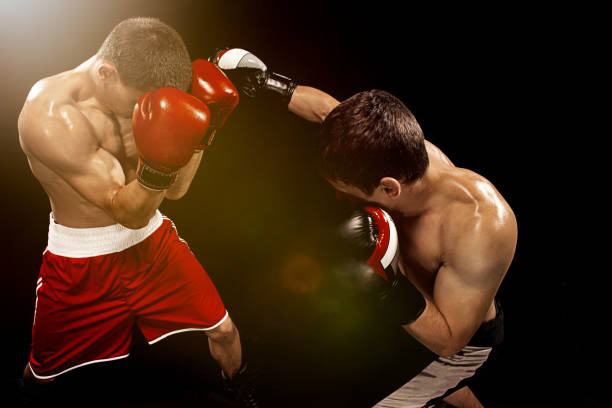istock Two professional boxer boxing on black background 813588326