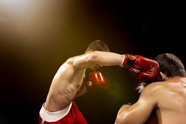 istock Two professional boxer boxing on black background 813588402