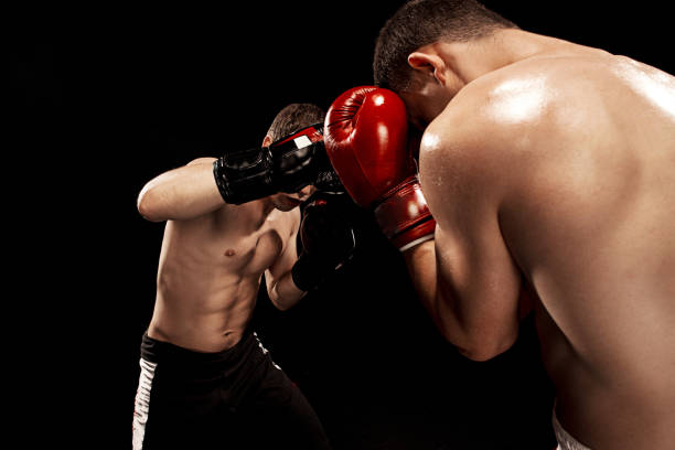 istock Two professional boxer boxing on black background 813590724