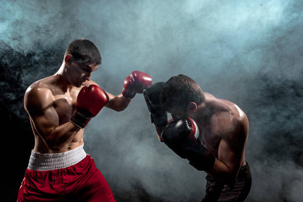istock Two professional boxer boxing on black smoky background 813590940