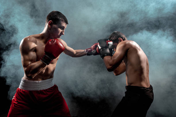 istock Two professional boxer boxing on black smoky background 813591046