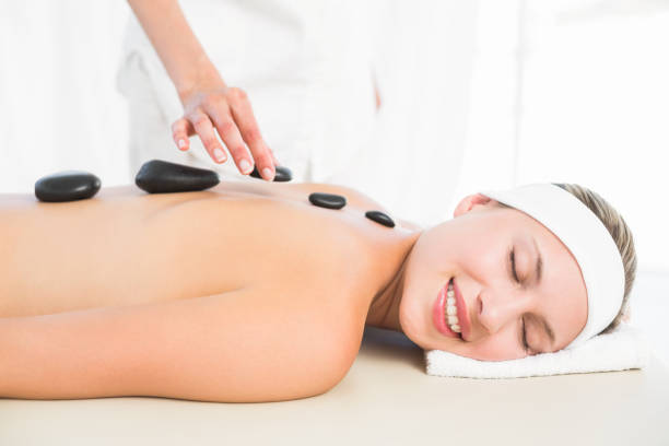 istock Beautiful blonde enjoying a hot stone massage 813591048