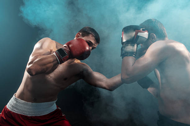 istock Two professional boxer boxing on black smoky background 813591082