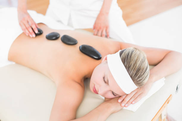 istock Beautiful blonde enjoying a hot stone massage 813591232