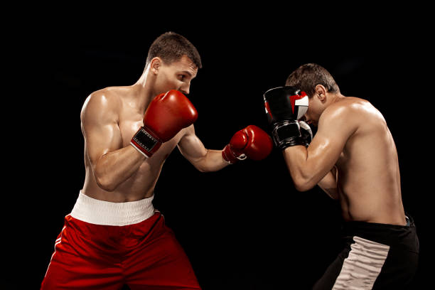 istock Two professional boxer boxing on black background 813591358