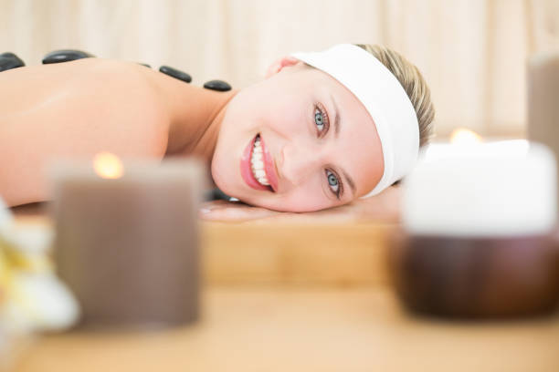 istock Beautiful blonde enjoying a hot stone massage 813591498