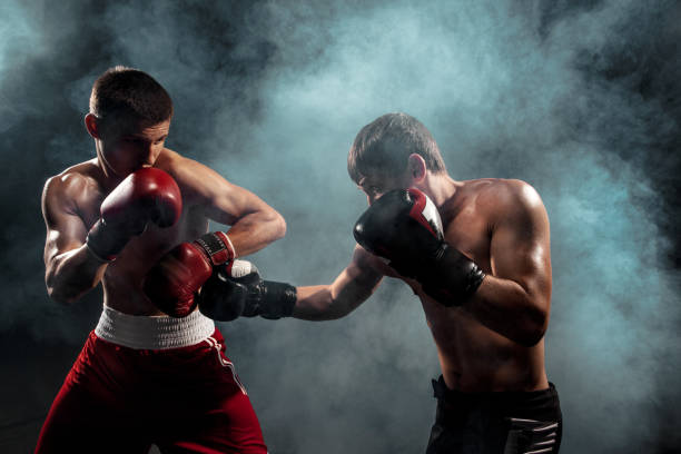 istock Two professional boxer boxing on black smoky background 813591534