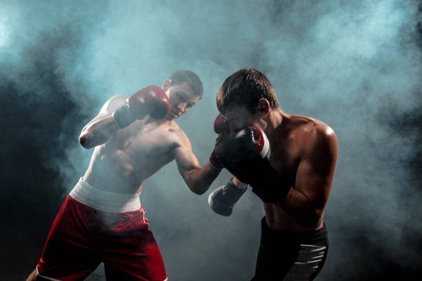 istock Two professional boxer boxing on black smoky background 813591560