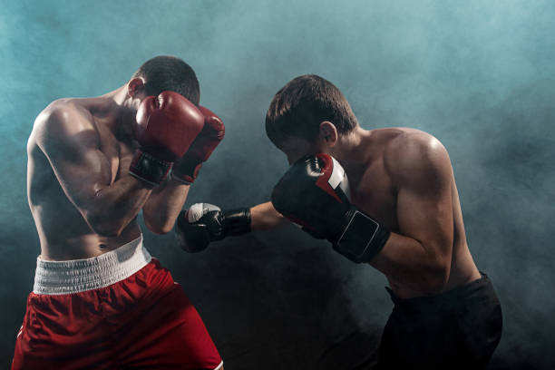 istock Two professional boxer boxing on black smoky background 813593642