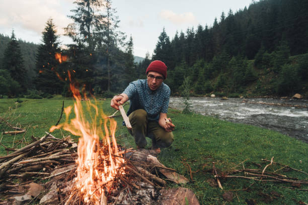 istock Man sitting near the campfire in camping 813593850