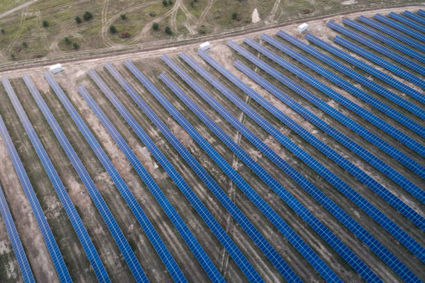 istock Solar panels placed on a countryside meadow. 813594074