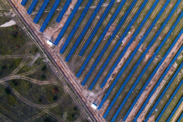 istock Solar panels placed on a countryside meadow. 813594252