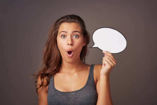You're not gonna believe this! Studio shot of an attractive young woman holding a blank speech bubble and looking shocked against a gray background youre beautiful quotes stock pictures, royalty-free photos & images