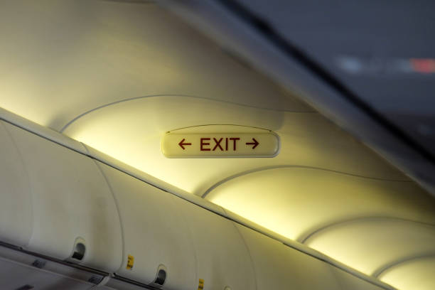 istock Emergency exit sign mounted above the head in the aircraft cabin 813604278