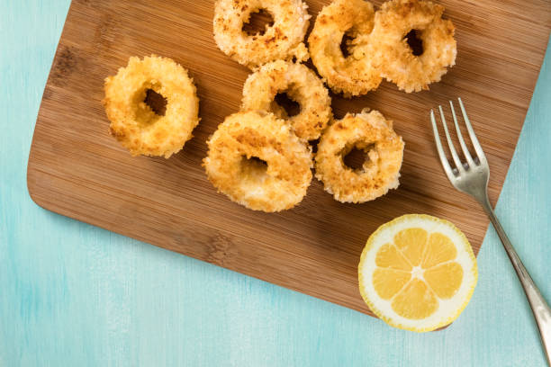 Calamari rings with lemon and copy space, overhead shot