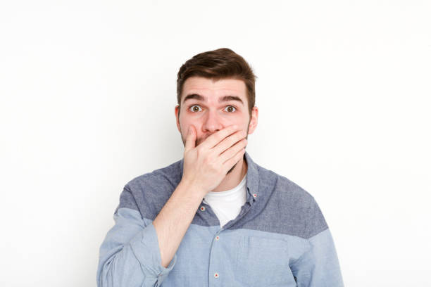 istock Surprised man covering mouth with hand 813618840