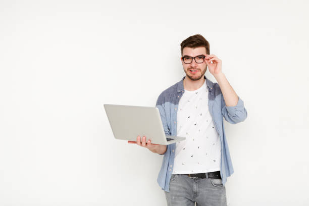 istock Young man standing with laptop 813619186