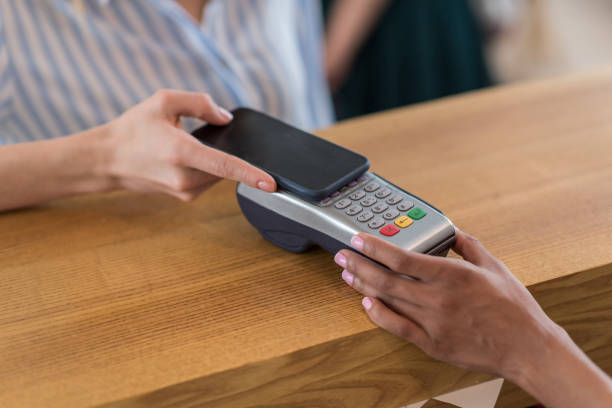 istock partial view of woman using smartphone for payment in cafe 813621440