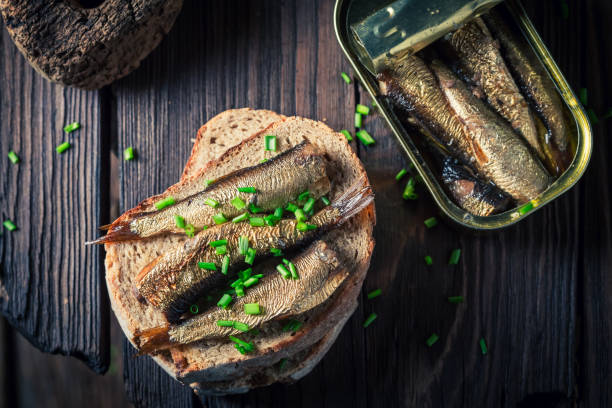 istock Tasty sandwich with sardines, chive and wholegrain bread 813621946