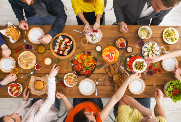istock People eat healthy meals at served table dinner party 813621968