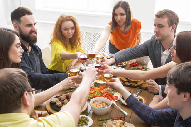istock People say cheers clink glasses at festive table dinner party 813622148