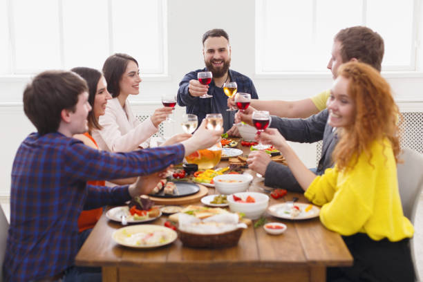 istock People say cheers clink glasses at festive table dinner party 813622360