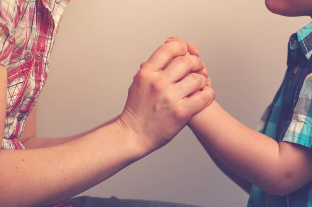 istock Closeup of woman's and child's hands 813622608