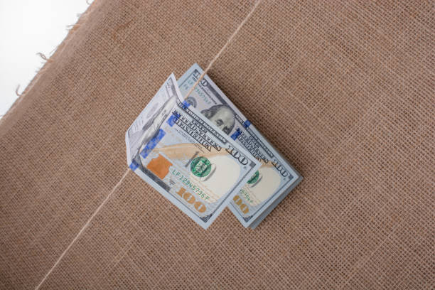 istock Banknote of US dollar hanging on a string 813625348
