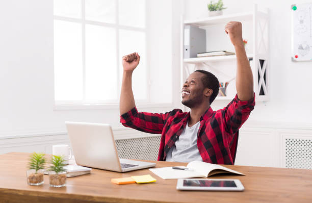 istock Happy businessman win. Winner, black man in office 813625824
