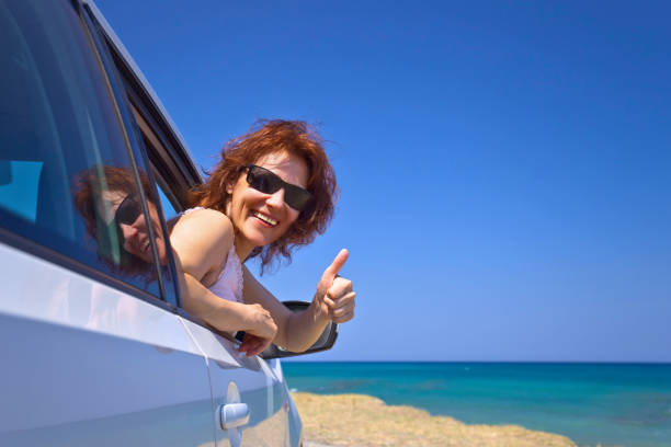 istock Happy woman travelling on a car . 813628462